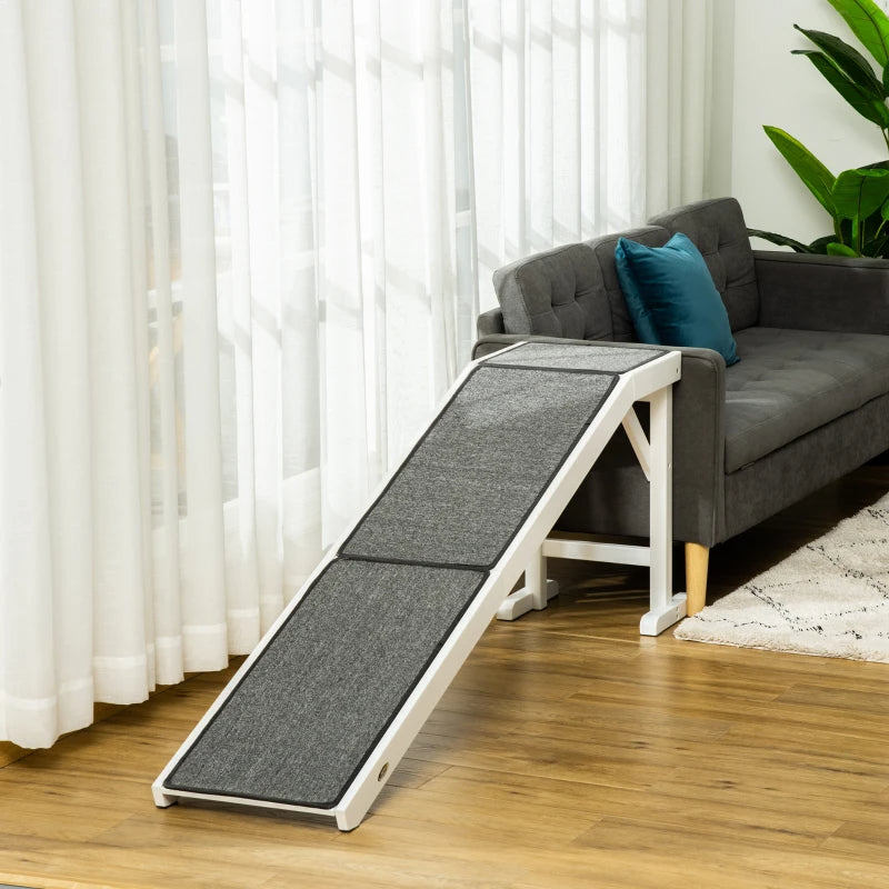 Pet ramp in a living room setting with a gray sofa and white curtains.