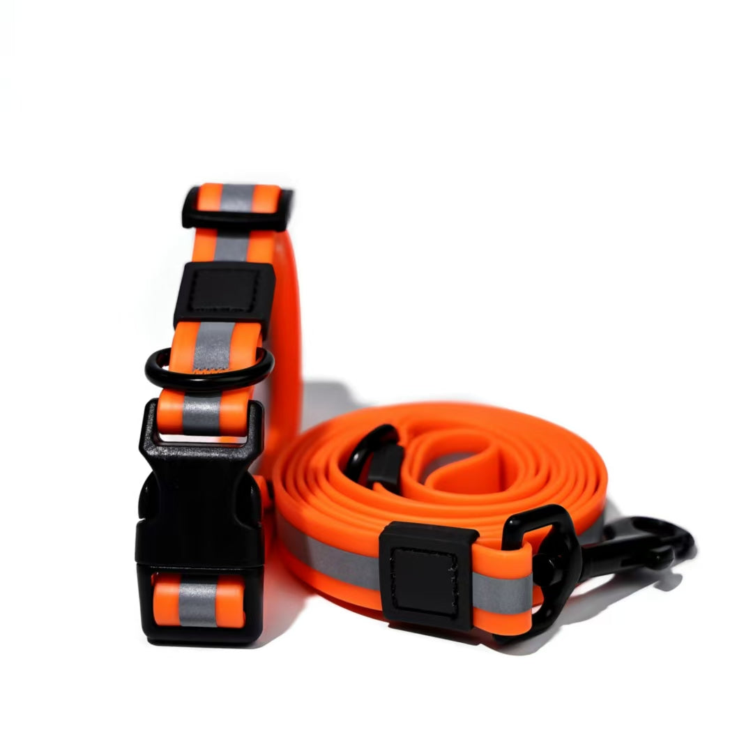 Orange dog collar and leash set with reflective stripes on a white background