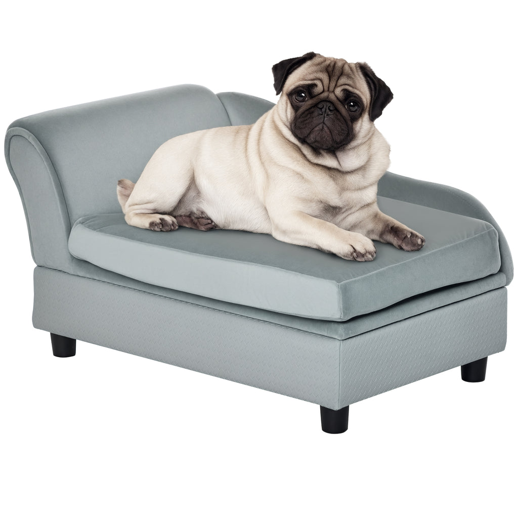 Pug lying on a small gray couch with a white background